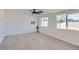 Bright bedroom featuring tile floors, two windows, a ceiling fan, and neutral paint at 5827 N 22Nd Dr, Phoenix, AZ 85015