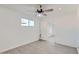 Bright bedroom features a ceiling fan, window, and a modern gray wood-look tile flooring at 5827 N 22Nd Dr, Phoenix, AZ 85015