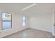 This bonus room has light gray wood-look tile flooring and dual windows for natural light at 5827 N 22Nd Dr, Phoenix, AZ 85015