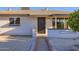 Front entrance showcasing a secured door, painted brick, decorative wall openings, and desert landscaping at 5827 N 22Nd Dr, Phoenix, AZ 85015