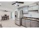 Modern kitchen with stainless steel refrigerator, gray cabinets, updated countertops and tiled backsplash at 5827 N 22Nd Dr, Phoenix, AZ 85015