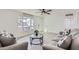 Cozy living area with a window view, ceiling fan, stylish sofas, and tile floors at 5827 N 22Nd Dr, Phoenix, AZ 85015