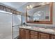 Bathroom with double sinks, granite countertops, a large mirror, and a glass-enclosed shower at 650 N Hawes Rd # 2819, Mesa, AZ 85207