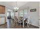 Light-filled dining area with a wooden table, stylish chairs, and large windows at 650 N Hawes Rd # 2819, Mesa, AZ 85207