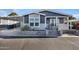 Charming home with well-maintained landscaping, front porch seating, and easy access with wide concrete steps at 650 N Hawes Rd # 2819, Mesa, AZ 85207