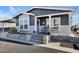 Charming home with well-maintained landscaping, front porch seating, and easy access with wide concrete steps at 650 N Hawes Rd # 2819, Mesa, AZ 85207
