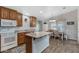 Well-equipped kitchen with island, wooden cabinets, and adjacent dining area, ideal for Gathering meals at 650 N Hawes Rd # 2819, Mesa, AZ 85207