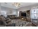 Cozy living room with a fireplace, TV, comfortable seating, and natural light at 650 N Hawes Rd # 2819, Mesa, AZ 85207