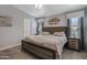 The main bedroom features neutral decor, two windows, and a comfortable bed at 650 N Hawes Rd # 2819, Mesa, AZ 85207