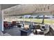 Covered patio with fire pit and seating offers views of the golf course beyond at 650 N Hawes Rd # 2819, Mesa, AZ 85207