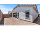 Exterior view of a stucco house with a covered patio and block fence enclosed backyard at 7421 S 76Th Ln, Laveen, AZ 85339