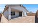 View of backyard featuring a covered patio and a sliding glass door for indoor/outdoor living at 7421 S 76Th Ln, Laveen, AZ 85339