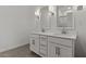 Bathroom featuring dual sinks with modern fixtures, and storage under the vanity at 7421 S 76Th Ln, Laveen, AZ 85339