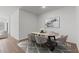 Dining room with an oval table, six chairs, modern rug and adjacent living area at 7421 S 76Th Ln, Laveen, AZ 85339