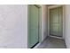 Hallway with two green interior doors and textured white walls at 7421 S 76Th Ln, Laveen, AZ 85339