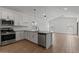 Modern kitchen with white cabinets, stainless steel appliances, and an open layout at 7421 S 76Th Ln, Laveen, AZ 85339