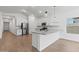Open-concept kitchen features white cabinets, stainless steel appliances, and a large island at 7421 S 76Th Ln, Laveen, AZ 85339