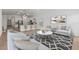 Inviting living room showcasing an open floor plan connecting to a modern kitchen with bar seating at 7421 S 76Th Ln, Laveen, AZ 85339