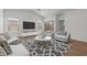 Well-lit living room featuring a sleek entertainment center and access to a private outdoor space at 7421 S 76Th Ln, Laveen, AZ 85339