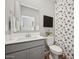 Bathroom featuring a gray vanity, decorative shower curtain, and modern fixtures at 7454 S 75Th Dr, Laveen, AZ 85339
