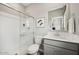 Bathroom features a shower with glass doors, a single sink vanity, and modern fixtures at 7454 S 75Th Dr, Laveen, AZ 85339