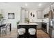 Modern kitchen showcasing gray cabinets, a center island, and stainless steel appliances at 7454 S 75Th Dr, Laveen, AZ 85339