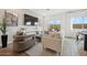 Bright living room with a large window and comfortable seating area at 7454 S 75Th Dr, Laveen, AZ 85339