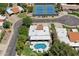 Aerial view featuring a large pool, umbrellas, and a tennis court in a residential neighborhood at 7835 E Cannon Dr, Scottsdale, AZ 85258