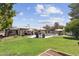 Expansive backyard with pool, patio, outdoor living area, and mature trees creates a private oasis at 7835 E Cannon Dr, Scottsdale, AZ 85258