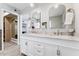 Main bathroom with a double vanity, marble countertops, and views into the walk in closet at 7835 E Cannon Dr, Scottsdale, AZ 85258