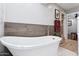 Modern bathroom showcasing a soaking tub, wood accent wall, and seamless design at 7835 E Cannon Dr, Scottsdale, AZ 85258