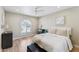 Serene bedroom with an arched window, neutral decor, and a plush upholstered bench at 7835 E Cannon Dr, Scottsdale, AZ 85258