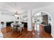 Bright dining area featuring hardwood floors, modern lighting, and views to the fireplace at 7835 E Cannon Dr, Scottsdale, AZ 85258