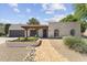 Charming home with a tile roof and well-manicured front yard, offering inviting curb appeal at 7835 E Cannon Dr, Scottsdale, AZ 85258