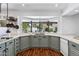 A kitchen with gray cabinets, quartz countertops, and a large bay window with views to the backyard at 7835 E Cannon Dr, Scottsdale, AZ 85258