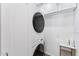 Efficient laundry room with stacked washer and dryer, storage cabinets, and ample counter space at 7835 E Cannon Dr, Scottsdale, AZ 85258