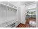 Well-organized mudroom with built-in bench, storage cubbies, and a nearby kitchen at 7835 E Cannon Dr, Scottsdale, AZ 85258