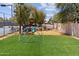 View of the neighborhood playground that includes a jungle gym, swings and lush, artificial turf at 7835 E Cannon Dr, Scottsdale, AZ 85258