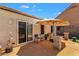 Backyard patio with outdoor seating and decor, featuring a sliding glass door to inside at 823 W Kyle Ct, Gilbert, AZ 85233