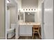 Bright bathroom featuring a vanity with makeup lighting, a toilet, and warm wood-look floors at 823 W Kyle Ct, Gilbert, AZ 85233