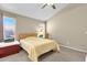 Cozy bedroom with neutral walls, two windows, a ceiling fan, and carpeted floors at 823 W Kyle Ct, Gilbert, AZ 85233