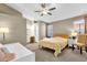Well-lit bedroom with a ceiling fan, large windows, and a daybed for guests at 823 W Kyle Ct, Gilbert, AZ 85233