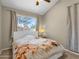 Bedroom features a patterned comforter, window with natural light, and neutral walls at 823 W Kyle Ct, Gilbert, AZ 85233