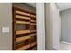 Organized closet includes built-in shelving with drawers, and a linen curtain at 823 W Kyle Ct, Gilbert, AZ 85233