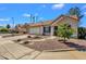 Well-maintained home with desert landscaping, and a spacious driveway, complemented by mature trees at 823 W Kyle Ct, Gilbert, AZ 85233