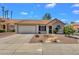 Charming single-story home showcasing a well-maintained front yard and a two-car garage at 823 W Kyle Ct, Gilbert, AZ 85233
