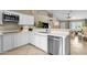 Bright kitchen features white cabinets, stainless steel appliances, and quartz countertops, open to the living area at 823 W Kyle Ct, Gilbert, AZ 85233