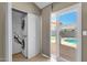 This laundry room features a stacked washer and dryer unit, and has a sliding door that leads to the backyard at 823 W Kyle Ct, Gilbert, AZ 85233