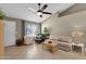 Bright living area with tiled floors, neutral paint, ceiling fan, and comfortable seating at 823 W Kyle Ct, Gilbert, AZ 85233