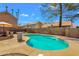 Backyard pool features a concrete patio, artificial turf, block fence, and shaded seating area at 823 W Kyle Ct, Gilbert, AZ 85233
